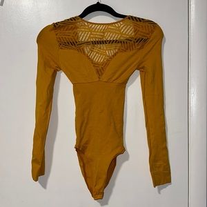 Colombian mustard colored waist cinching bodysuit fits size small and medium